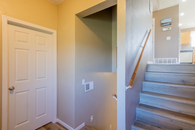 staircase with visible vents and baseboards