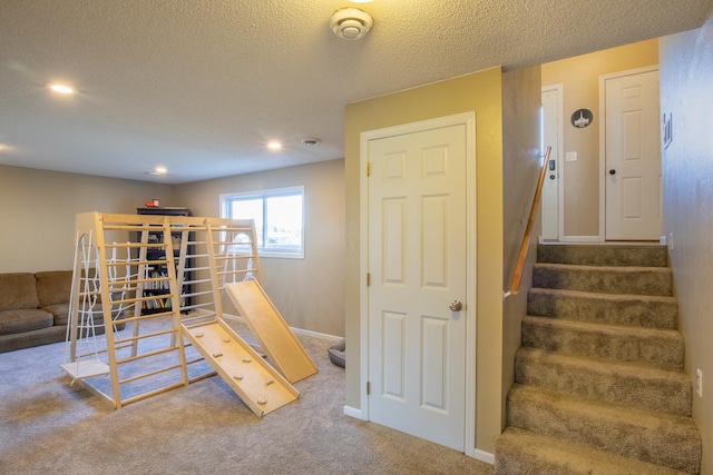 playroom with a textured ceiling, carpet floors, recessed lighting, and baseboards