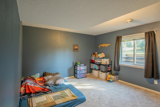 interior space featuring a textured ceiling and baseboards