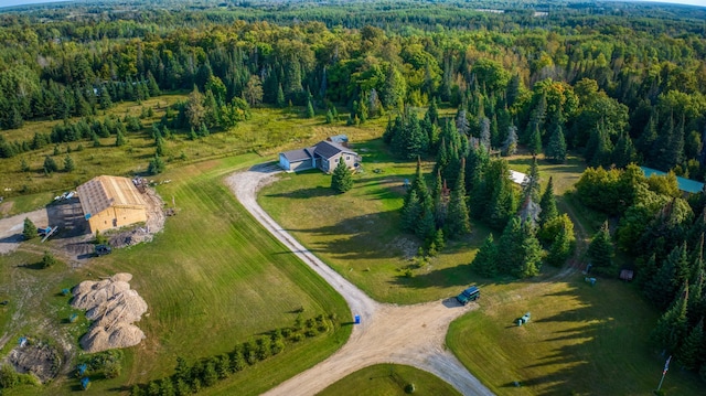 drone / aerial view with a wooded view