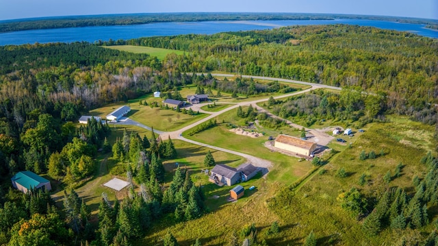 aerial view with a water view and a forest view