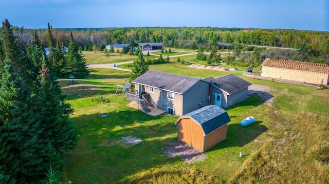 drone / aerial view featuring a forest view