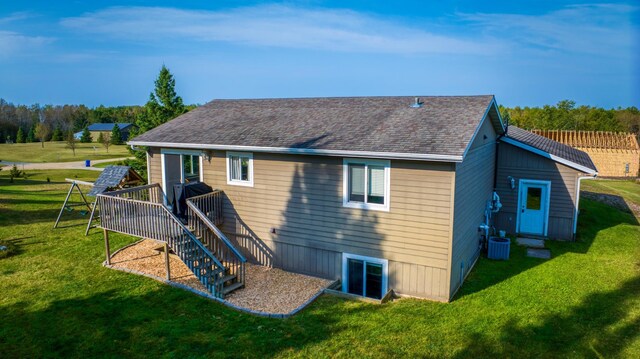 back of house featuring a shingled roof, stairway, a yard, a wooden deck, and central air condition unit