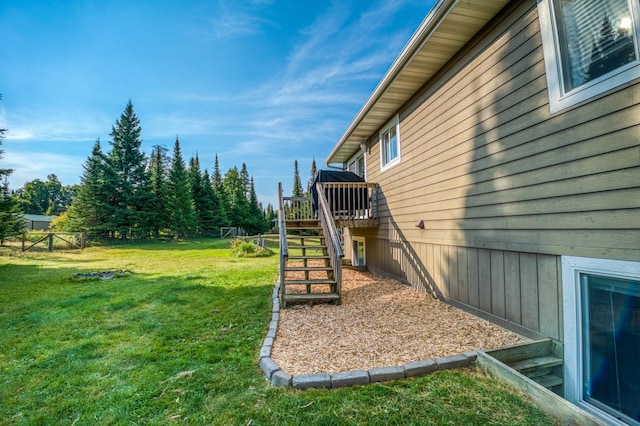 view of yard with fence, stairway, and a deck