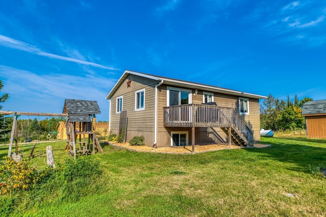 back of house with stairs, a lawn, a playground, and a wooden deck