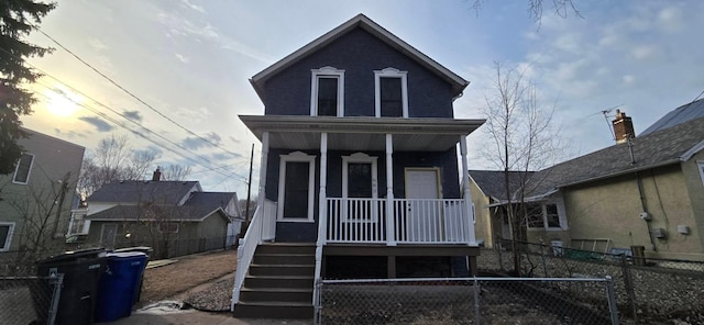 view of front of house featuring a fenced front yard and covered porch