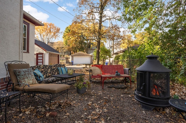 view of patio featuring an outbuilding, fence, and an outdoor hangout area