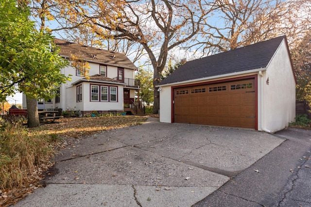 view of front of house featuring an outdoor structure and a detached garage