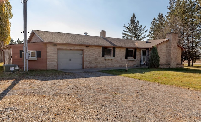 ranch-style home with driveway, a garage, brick siding, a chimney, and a front yard