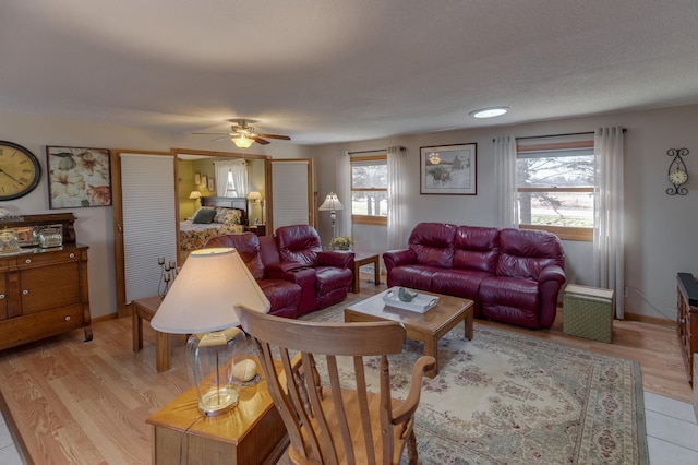 living room featuring a healthy amount of sunlight, light wood-style flooring, and baseboards