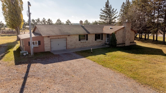 ranch-style home featuring an attached garage, a shingled roof, driveway, a front lawn, and a chimney