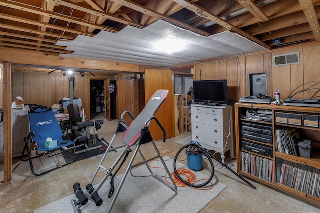 exercise area with visible vents and wood walls