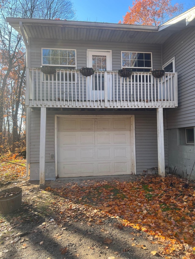 back of house featuring a garage and a balcony