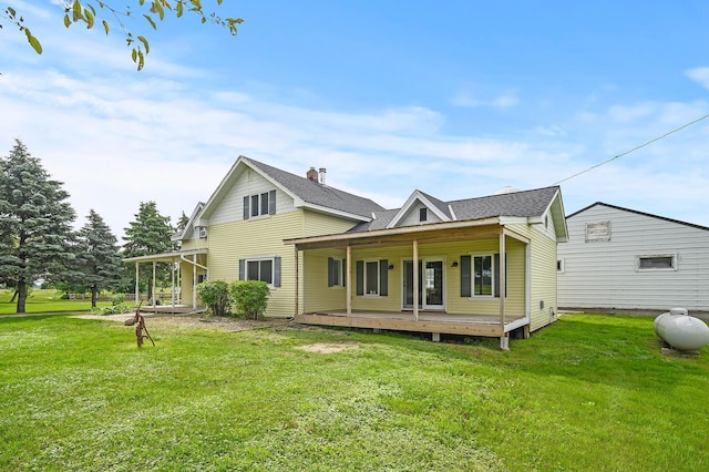 back of property with a porch and a yard