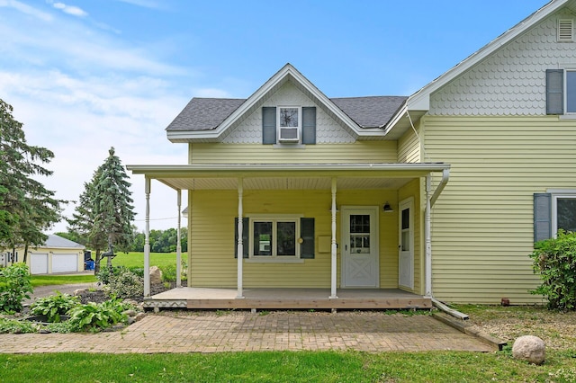 view of front of property with covered porch and a shingled roof