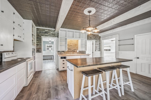 kitchen featuring white appliances, dark wood-type flooring, wood counters, and an ornate ceiling