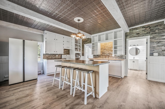 kitchen with white appliances, an ornate ceiling, a kitchen island, white cabinetry, and open shelves