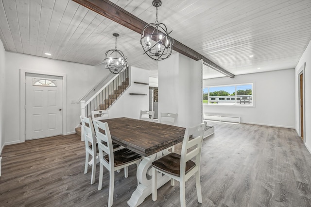 dining room with stairs, baseboard heating, wood finished floors, and baseboards