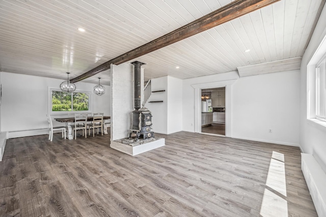 basement featuring a chandelier, wooden ceiling, recessed lighting, wood finished floors, and baseboard heating