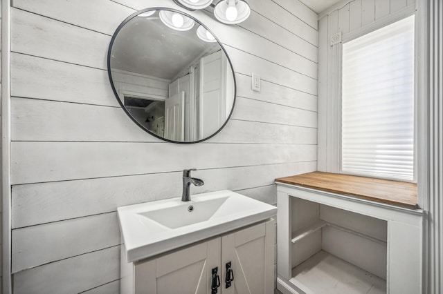 bathroom with wooden walls and vanity