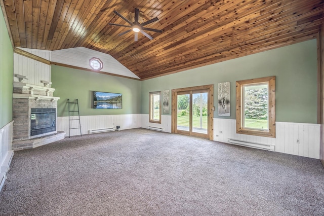 unfurnished living room with a baseboard heating unit, a brick fireplace, wood ceiling, and wainscoting