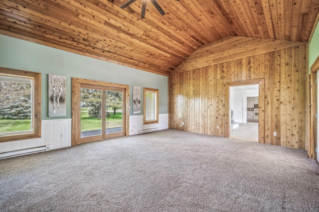 empty room with lofted ceiling, wood walls, wood ceiling, baseboard heating, and carpet