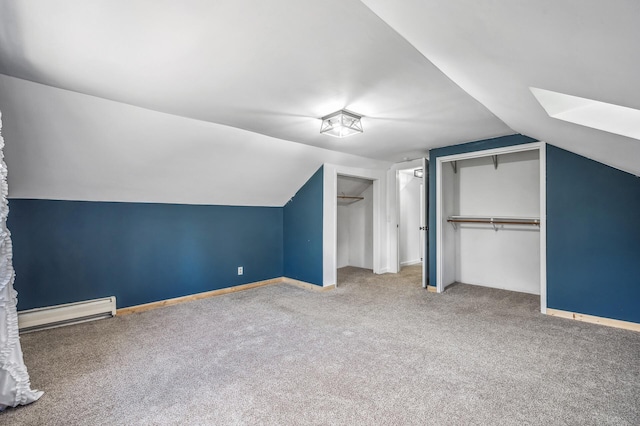 additional living space featuring carpet, lofted ceiling, baseboards, and baseboard heating