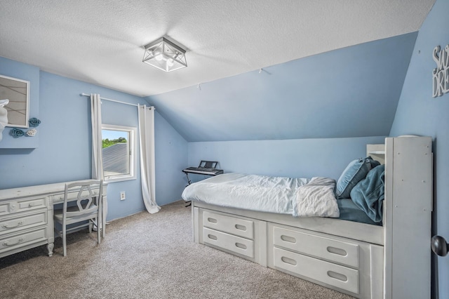 carpeted bedroom featuring vaulted ceiling and a textured ceiling