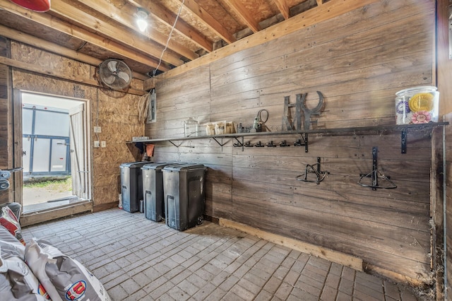 interior space featuring brick floor and wooden walls