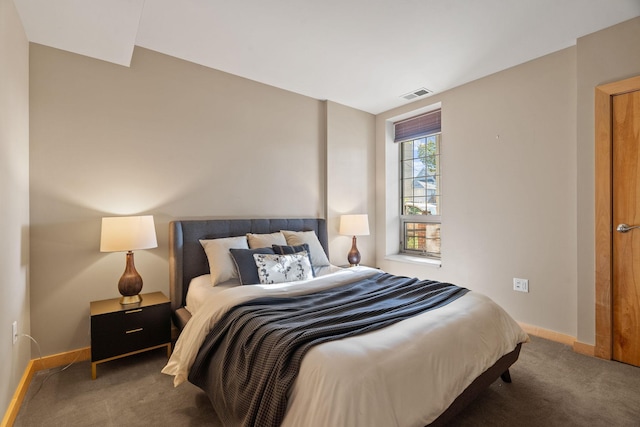 carpeted bedroom featuring visible vents and baseboards