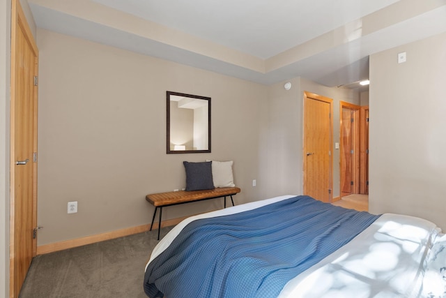 bedroom with carpet floors and baseboards