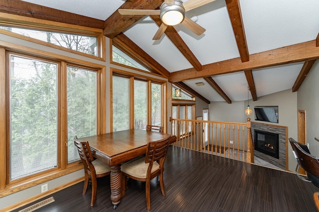 1509 Woodland Dr SW, Rochester, MN 55902 - dining space featuring a glass covered fireplace, plenty of natural light, lofted ceiling with beams, and a ceiling fan