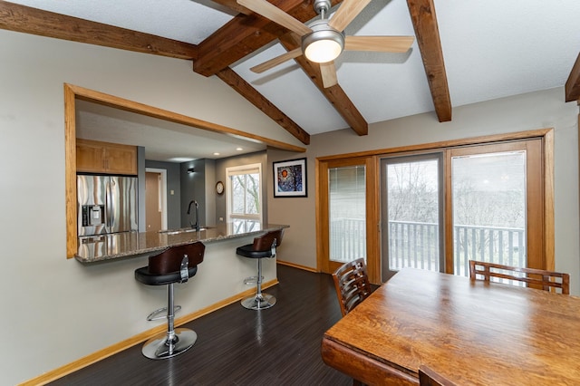 1509 Woodland Dr SW, Rochester, MN 55902 - dining room with baseboards, ceiling fan, vaulted ceiling with beams, and dark wood-type flooring