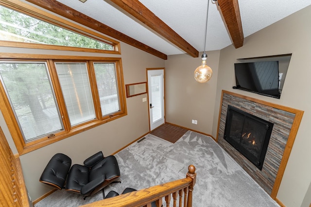 1509 Woodland Dr SW, Rochester, MN 55902 - living area with visible vents, baseboards, a glass covered fireplace, vaulted ceiling with beams, and carpet