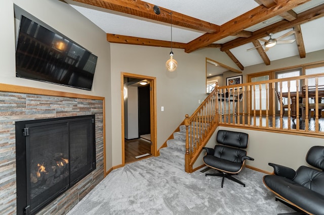 1509 Woodland Dr SW, Rochester, MN 55902 - carpeted living area featuring a ceiling fan, baseboards, a stone fireplace, and vaulted ceiling with beams
