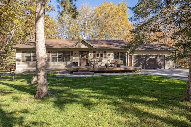 ranch-style home with an attached garage, driveway, and a front lawn