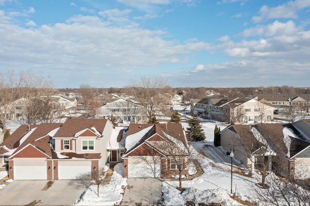 snowy aerial view with a residential view