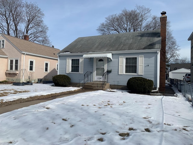 bungalow featuring a chimney