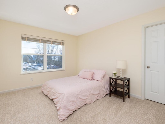 carpeted bedroom featuring baseboards