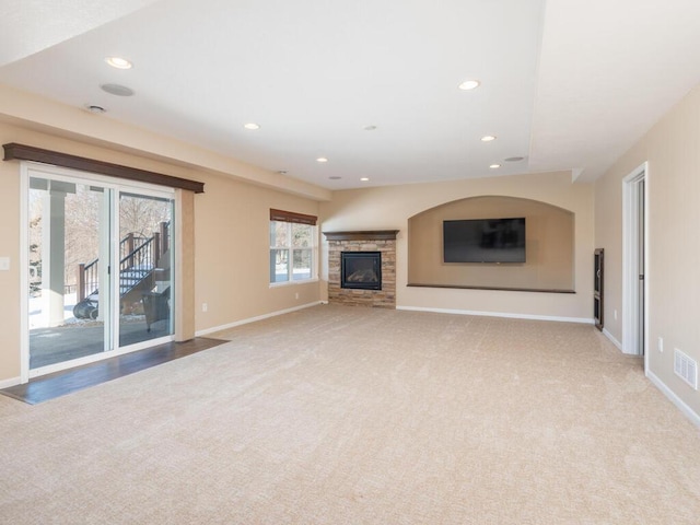 unfurnished living room with recessed lighting, carpet flooring, visible vents, and baseboards