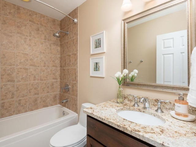 bathroom with shower / washtub combination, vanity, and toilet