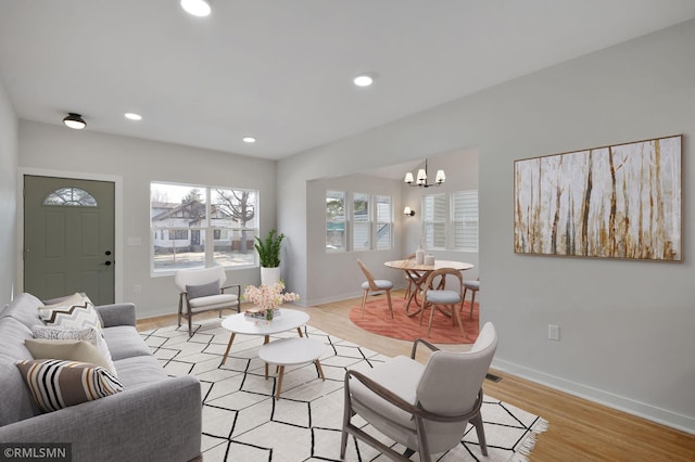 living room featuring light wood-type flooring and baseboards