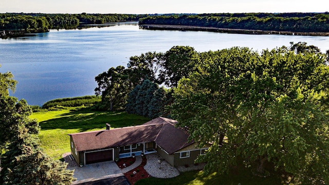 birds eye view of property with a water view and a wooded view