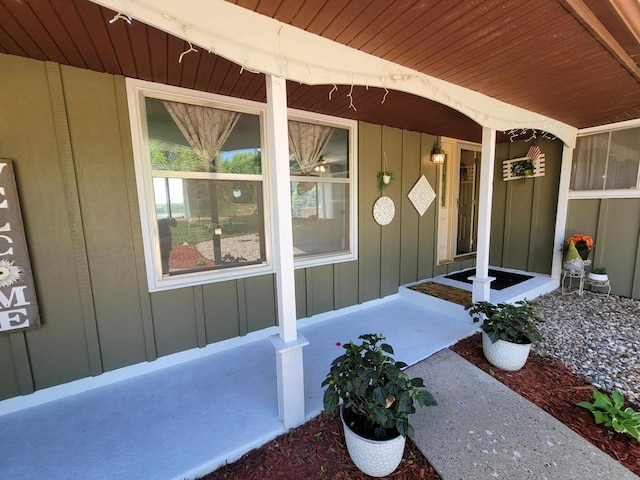 entrance to property with covered porch and board and batten siding