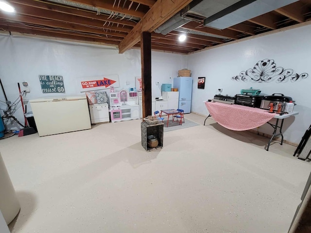 unfinished basement featuring water heater and fridge