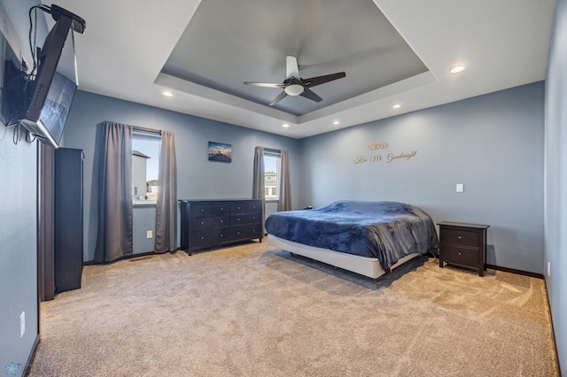 bedroom featuring ceiling fan, a tray ceiling, carpet, and recessed lighting