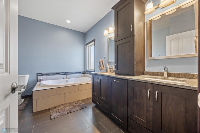 full bath with double vanity, a garden tub, and a sink