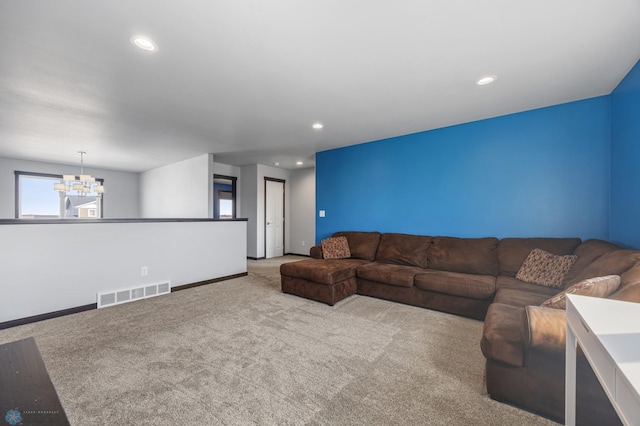 carpeted living room with baseboards, visible vents, a chandelier, and recessed lighting