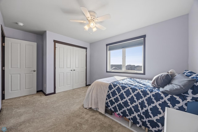 carpeted bedroom featuring ceiling fan, a closet, and baseboards