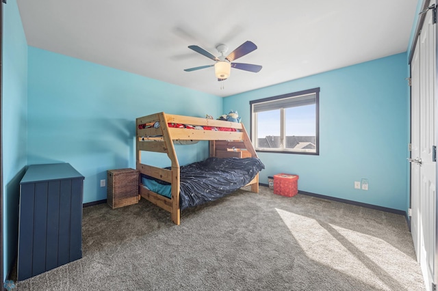 carpeted bedroom with ceiling fan and baseboards